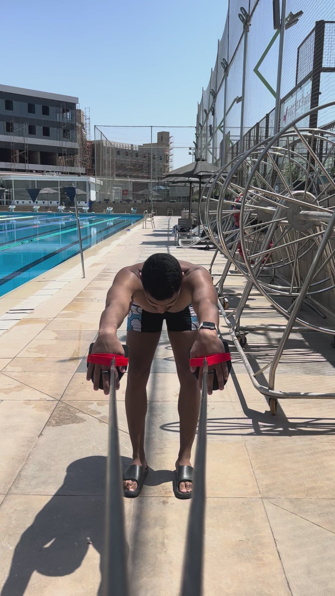 Swimming fitness cord with paddles